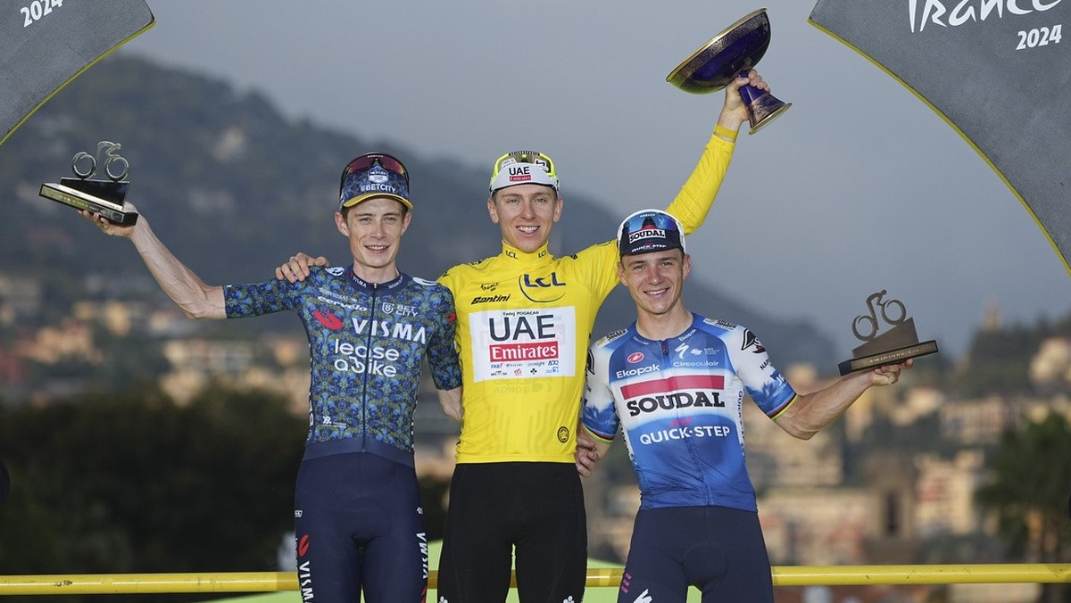 Tour de France winner Slovenia's Tadej Pogacar, wearing the overall leader's yellow jersey, Denmark's Jonas Vingegaard, left, and second place, and Belgium's Remco Evenepoel, right ...