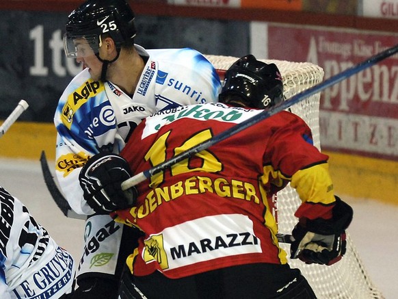 Marc Leuenberger, Mitte, von Langnau, kaempft gegen Krisjanis Redlihs, rechts, und Adam Munro, rechts, im Eishockeyspiel der NLA SCL Tigers gegen HC Fribourg Gotteron, am Freitag, 22. Septermber 2006  ...