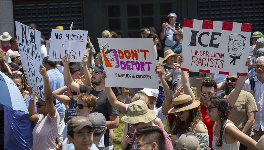 epa06852918 Protesters hold signs that read &quot;No Human is Illegal, &quot; &quot;Don&#039;t Deport Families &amp; Refugees,&quot; and &quot;ICE - Finger Lickin&#039; Racists,&quot; as they and thou ...