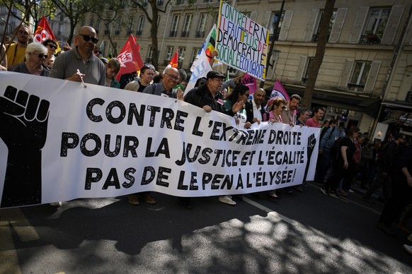 Demonstrators hold a banner reading: Against far-right. For justice. No Le Pen at Elysee, during a protest against far-right in Paris, Saturday, April 16, 2022. Far-right leader Marine Le Pen is tryin ...