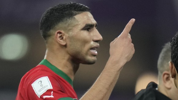 Morocco&#039;s Achraf Hakimi, left, gestures as he interacts with the referee during the World Cup third-place playoff soccer match between Croatia and Morocco at Khalifa International Stadium in Doha ...