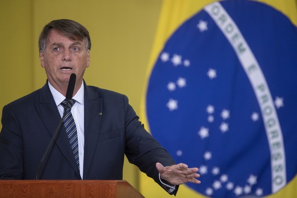 epa09849211 The president of Brazil, Jair Bolsonaro, participates in a ceremony for the Launch of New Deliveries of the Income and Opportunity Program at the Palacio do Planalto, in Brasilia, Brazil,  ...