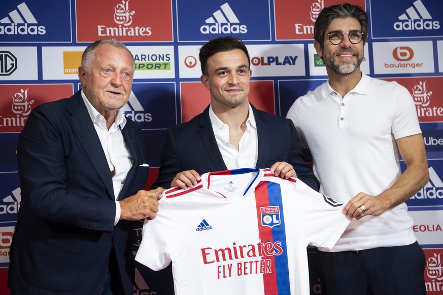 Switzerland soccer player Xherdan Shaqiri, centre, poses with his new Olympique Lyonnais jersey with Jean-Michel Aulas, left, president of Olympique Lyonnais and Juninho, right, sport director of Olym ...