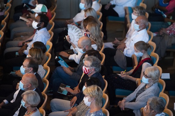 THEMENBILD --- ZUR WIEDERAUFNAHME VON GROSSVERANSTALTUNGEN UNTER STRENGEN CORONA-AUFLAGEN --- Zuschauer mit Schutzmasken bei einem Konzert des Sinfonieorchesters unter dem Titel "Willkommen zurue ...