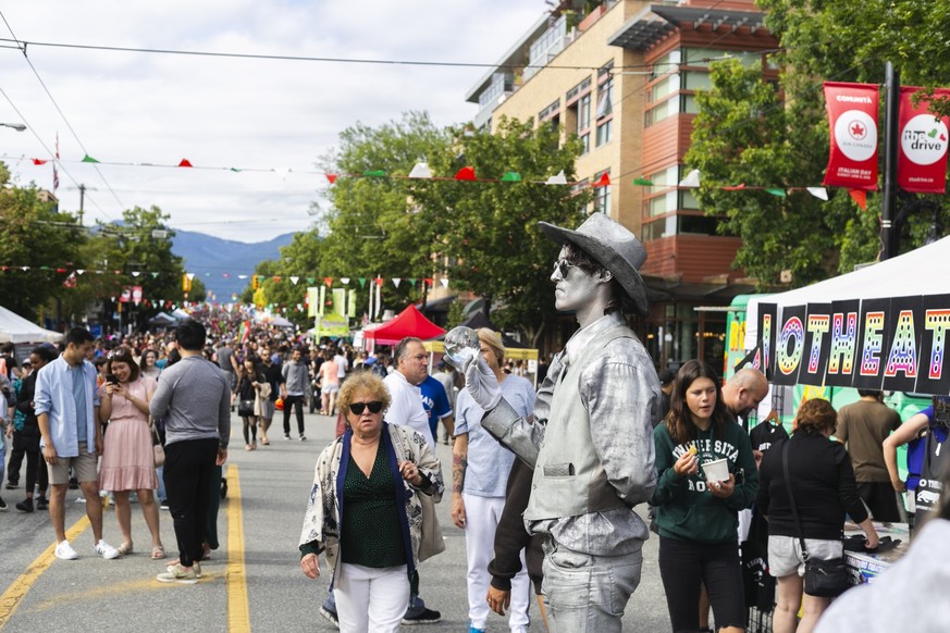 VANCOUVER, CANADA - JUNE 09, 2014: Italian day in Commercial drive. Street artist showing living silver statue. xkwx vancouver, people, italian, crowd, street, young, city, culture, celebration, life, ...