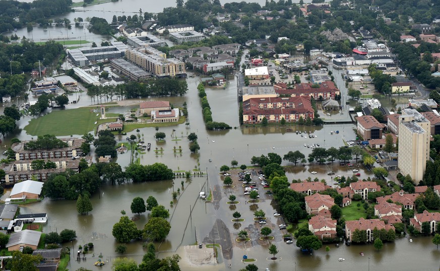 This aerial image shows flooded areas on the campus of LSU, Saturday, Aug. 13, 2016, in Baton Rouge, La. Louisiana Gov. John Bel Edwards says more than 1,000 people in south Louisiana have been rescue ...