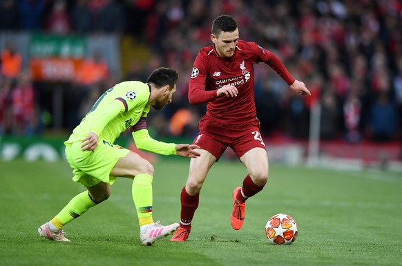 epa07554485 Andy Robertson (R) of Liverpool and Lionel Messi of Barcelona in action during the UEFA Champions League semi final second leg soccer match between Liverpool FC and FC Barcelona at Anfield ...