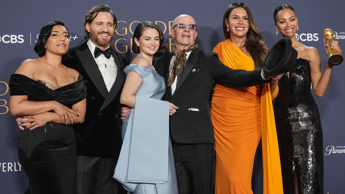 Adriana Paz, from left, Edgar Ramirez, Selena Gomez, Jacques Audiard, Karla Sofia Gascon, and Zoe Saldana pose in the press room with the award for best motion picture - musical or comedy for "Em ...