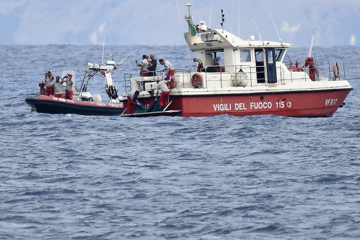 Italian Firefighters scuba divers bring ashore in a green bag the body of one of the victims of the UK flag vessel Bayesian, Wednesday, Aug. 21, 2024. The sail yacht was hit by a violent sudden storm  ...