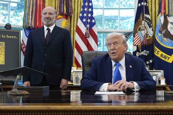 President Donald Trump speaks as Commerce Secretary Howard Lutnick listens in the Oval Office of the White House, Friday, Sept. 19, 2025, in Washington. (AP Photo/Alex Brandon)
Donald Trump