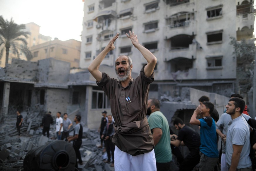 231014 -- GAZA, Oct. 14, 2023 -- People search for survivors among rubble of a building after an Israeli air strike in the southern Gaza Strip city of Khan Younis, Oct. 14, 2023. The ongoing conflict ...