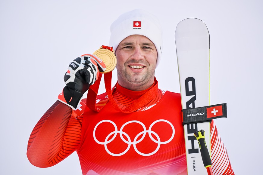 epa09734945 Gold medalist Beat Feuz of Switzerland celebrates during the medal ceremony for the Men&#039;s Downhill race of the Alpine Skiing events of the Beijing 2022 Olympic Games at the Yanqing Na ...