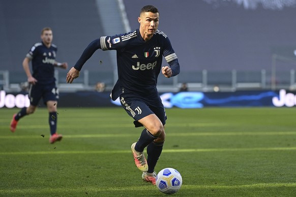 Juventus' Cristiano Ronaldo runs with the ball during the Serie A soccer match between Juventus and Benevento at the Allianz stadium in Turin, Italy, Sunday, March 21, 2021. (Marco Alpozzi/LaPres ...