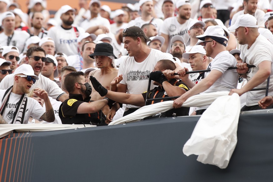 Fans argue with organizing staff as they try to move a banner before the Europa League final soccer match between Eintracht Frankfurt and Rangers FC at the Ramon Sanchez Pizjuan stadium in Seville, Sp ...