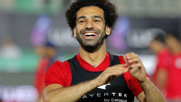 Egyptian national team soccer player and Liverpool&#039;s star striker Mohammed Salah smiles as he greets fans during the final training of the national team at Cairo Stadium in Cairo, Egypt, Saturday ...