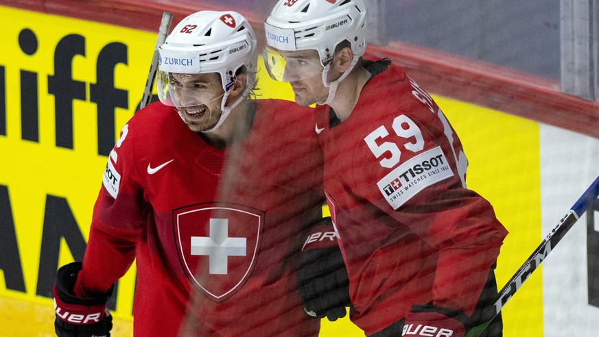 epa09953543 Switzerland&#039;s Dario Simion (R) and Denis Malgin celebrate their second goal during the Ice Hockey World Championship group A preliminary round match between Switzerland and Kazachstan ...