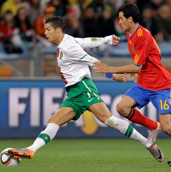 FILE - Followed by Spain's Sergio Busquets, Portugal's Cristiano Ronaldo controls the ball during the World Cup round of 16 soccer match between Spain and Portugal at the Green Point stadium ...