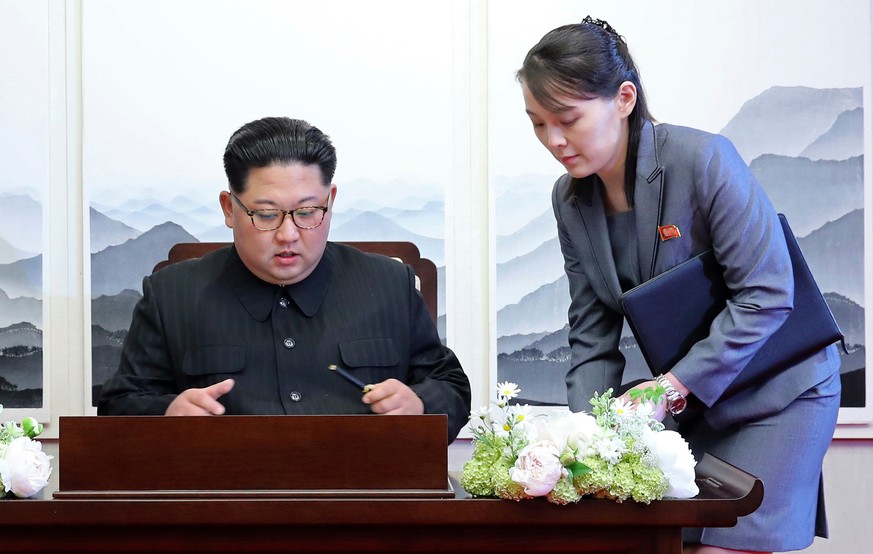 FILE - In this April 27, 2018, file photo, North Korean leader Kim Jong Un signs a guestbook next to his sister Kim Yo Jong, right, inside the Peace House at the border village of Panmunjom in Demilit ...