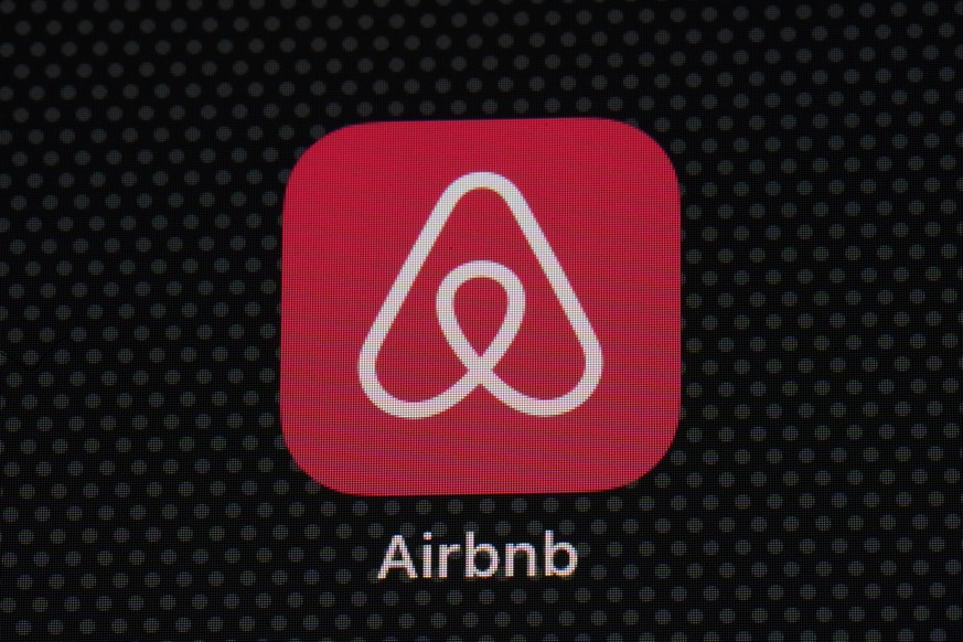 FILE - The Airbnb app icon is displayed on an iPad screen in Washington, D.C., on May 8, 2021. NerdWallet looked at the price of 1,000 Airbnb listings and compared them to the cost of hotels. Airbnbs  ...
