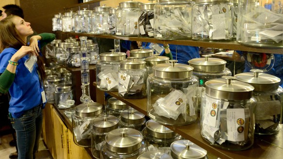 epa04005555 A sales clerk looks through various blends of marijuana to fill an order for a customer at the Denver Discreet Disensary in Denver, Colorado, USA, 31 May 2013. Colorado is the first state  ...