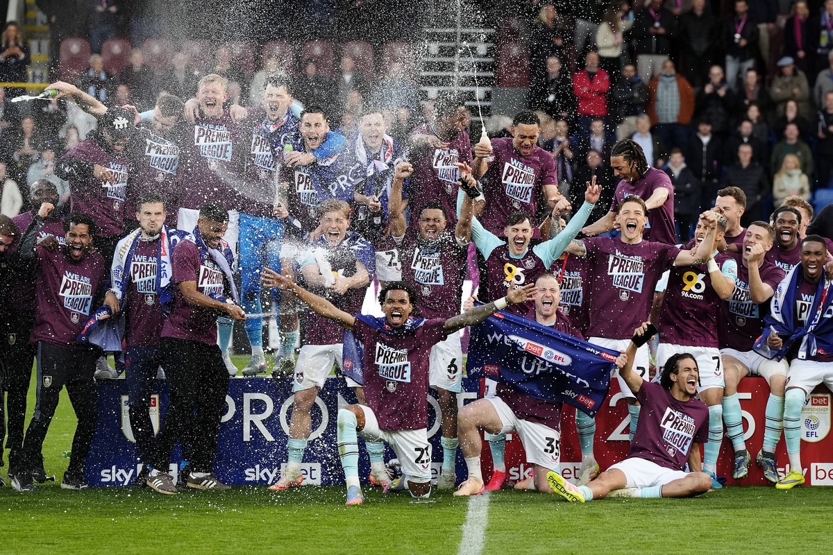 Burnley players celebrate their promotion to the English Premier League after the Championship soccer match against Sheffield United at Turf Moor, Burnley, England, Monday April 21, 2025. (Nick Potts/ ...