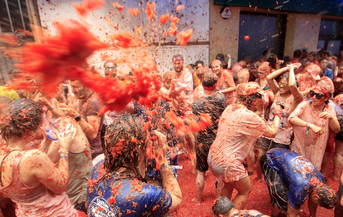Revelers enjoy as they throw tomatoes at each other, during the annual "Tomatina", tomato fight fiesta, in the village of Bunol, 50 kilometers outside Valencia, Spain, Wednesday, Aug. 30, 20 ...