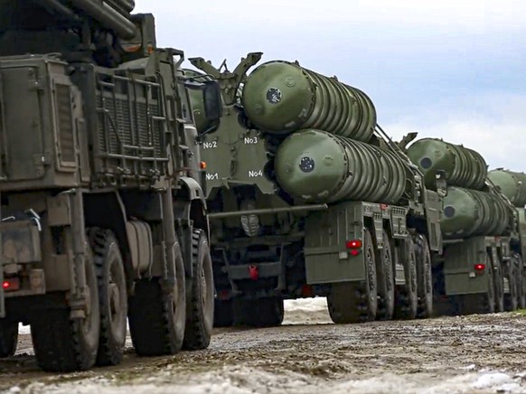 In this photo taken from video provided by the Russian Defense Ministry Press Service on Thursday, Feb. 10, 2022, Combat crews of the S-400 air defense system drive to take up combat duty at the train ...