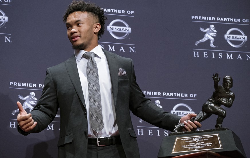 FILE - In this Dec. 8, 2018, file photo, Oklahoma quarterback Kyler Murray holds the Hesiman Trophy after winning the award in New York. Murray&#039;s locker remained empty on Monday, Feb. 11, 2019, i ...