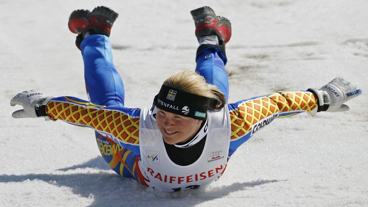 Picture 4 of 4 - Anja Paerson of Sweden runs to do her traditional victory jump and slide in the finish area after winning the women's World Cup Super-G during the Alpine Ski World Cup finals, in ...