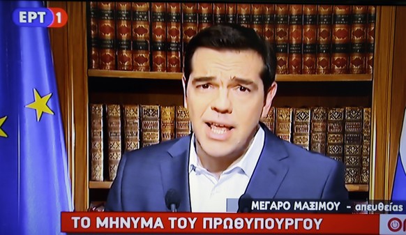 In this photo taken from television Greece&#039;s Prime Minister Alexis Tsirpas delivers a televised address to the nation from his office at Maximos Mansion in Athens, Wednesday, July 1, 2015. Tsipra ...