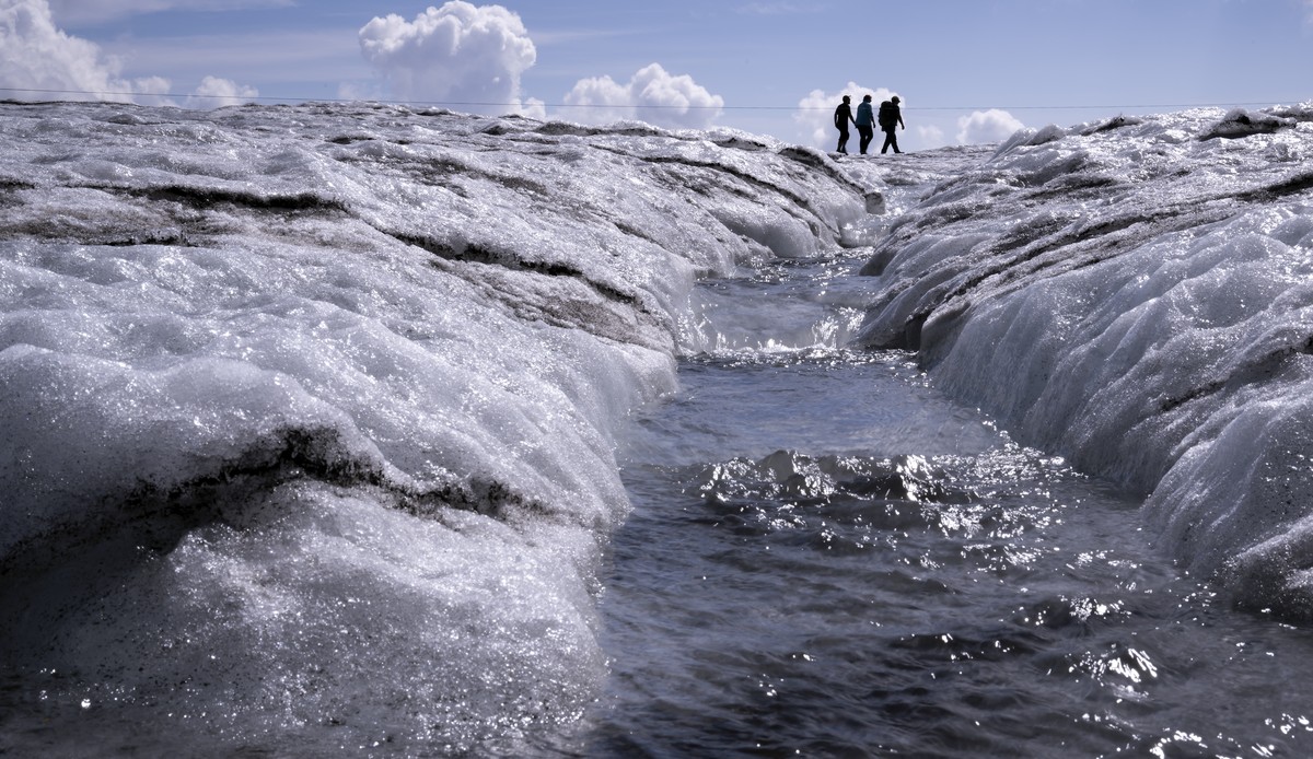 People walk on the Tsanfleuron Glacier at the "Glacier 3000" alpine resort, above Les Diablerets, Switzerland, Saturday, August 6, 2022. The Swiss Glacier Monitoring Switzerland (GLAMOS), fe ...