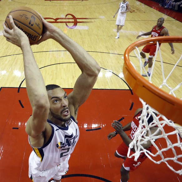 Utah Jazz center Rudy Gobert (27) scores past Houston Rockets guard James Harden (13) during the first half in Game 5 of an NBA basketball playoff series, in Houston, Wednesday, April 24, 2019. (AP Ph ...