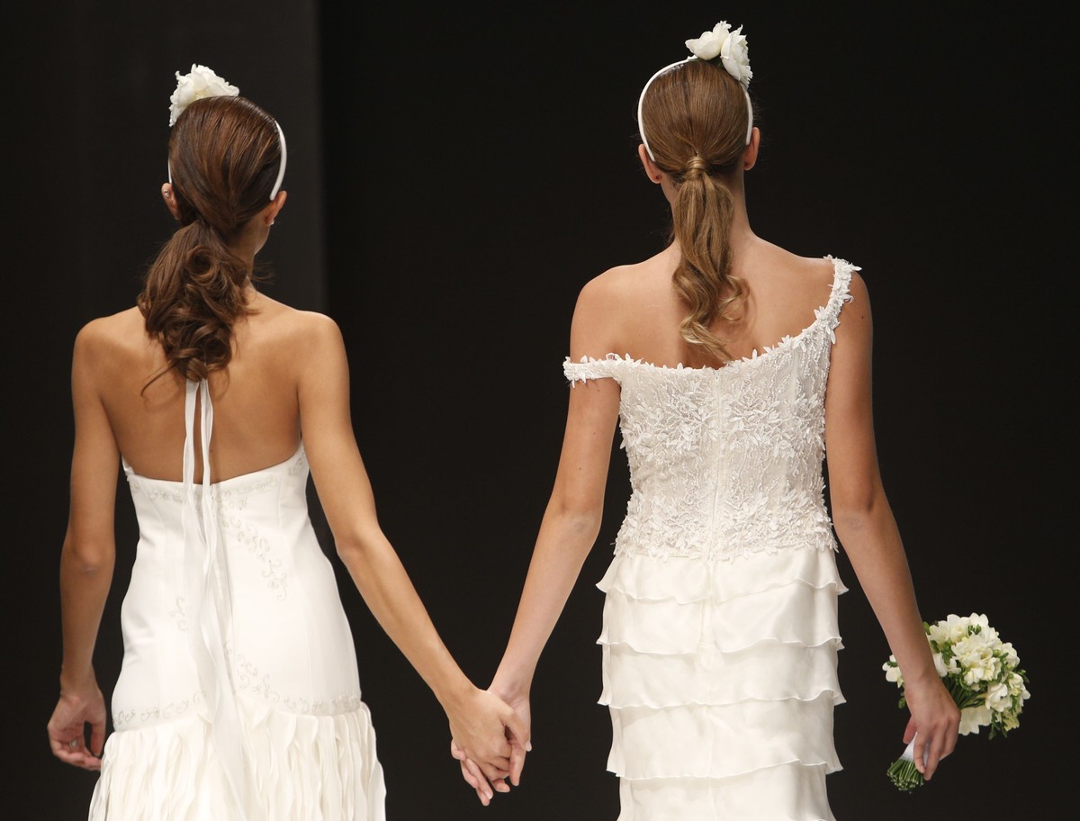 FILE - Models on the catwalk during a wedding fashion show with same-sex couples, dubbed "The rainbow wedding fashion show", part of a 'wedding fair' taking place in Rome, Thursday ...