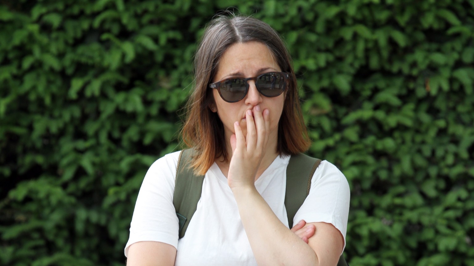 epa10681009 A woman reacts at the scene of a knife attack in the Paquier d'Annecy park in Annecy, France, June 09, 2023. On June 08, a man had carried out an attack with a knife in which he had at least ...