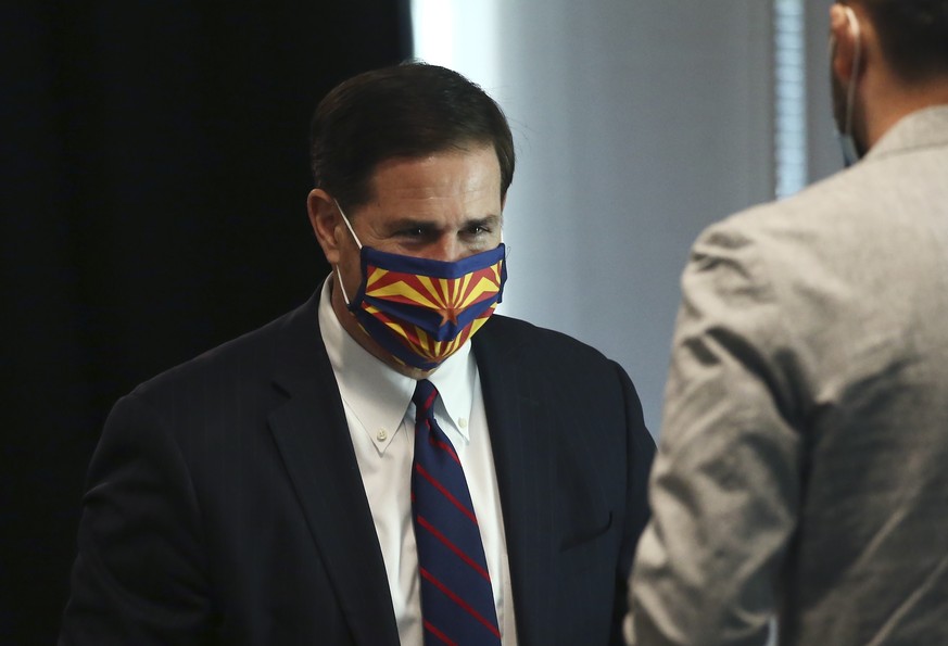 Arizona Gov. Doug Ducey wears a face covering due to the coronavirus at a news conference Wednesday, June 24, 2020, in Phoenix. (AP Photo/Ross D. Franklin)