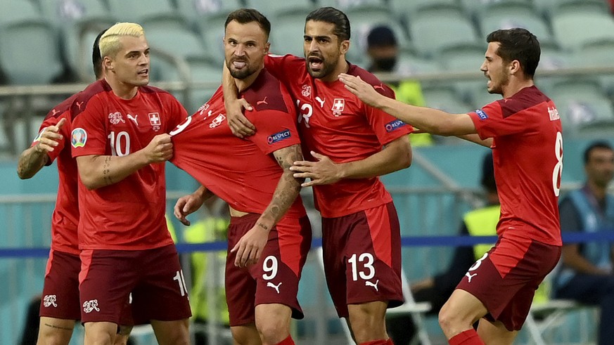 Switzerland&#039;s Haris Seferovic, centre, celebrates with teammates after scoring their side&#039;s first goal during the Euro 2020 soccer championship group A match between Switzerland and Turkey a ...