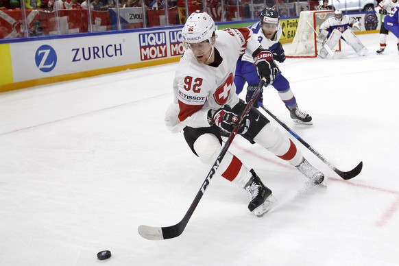 Switzerland&#039;s forward Gaetan Haas, left, vies for the puck with Slovakia&#039;s defender Adam Janosik, right, during the IIHF 2018 World Championship preliminary round game between Slovakia and S ...