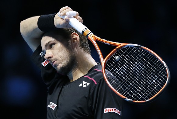 Stan Wawrinka of Switzerland wipes his face after he plays a return to Rafael Nadal of Spain during their singles tennis match at the ATP World Tour Finals at the O2 Arena in London, Monday, Nov. 16,  ...