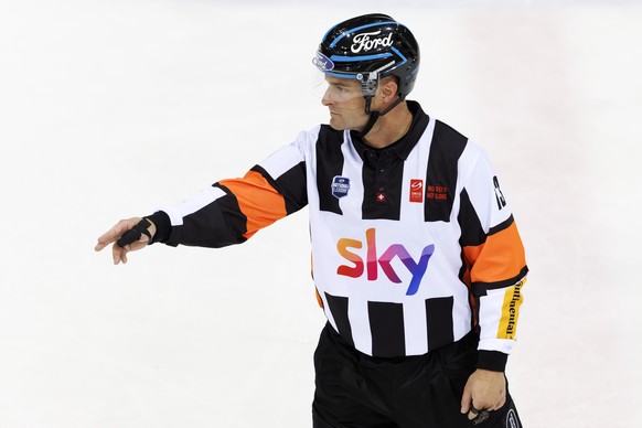 The head referee Stefan Huerlimann gestures, during a National League regular season game of the Swiss Championship between Geneve-Servette HC and SCL Tigers, at the ice stadium Les Vernets, in Geneva ...