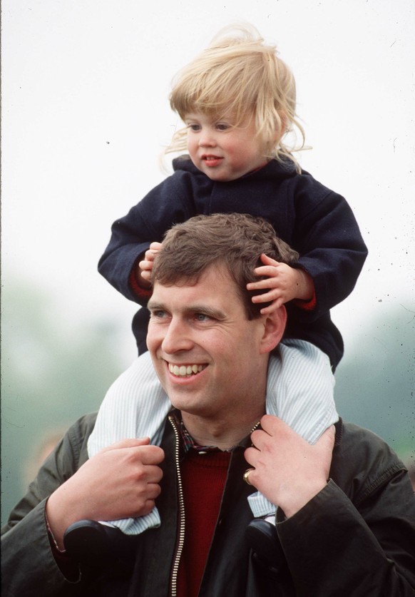 WINDSOR, UNITED KINGDOM -MAY 12: Prince Andrew carries Princess Beatrice on his shoulders at the Royal Windsor Horse Show in Windsor, England on May 12, 1990. (Photo by Anwar Hussein/Getty Images)