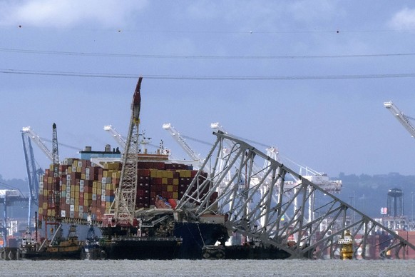 FILE - The collapsed Francis Scott Key Bridge rests on the container ship Dali, May 12, 2024, in Baltimore, as seen from Riviera Beach, Md. The main shipping channel into Baltimore&#039;s port has ful ...