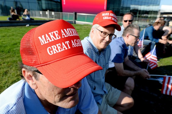 People wear Make America Great Again caps at an event called Helsinki Loves Trump, in Helsinki, Wednesday, July 11, 2018. (Mikko Stig/Lehtikuva via AP)