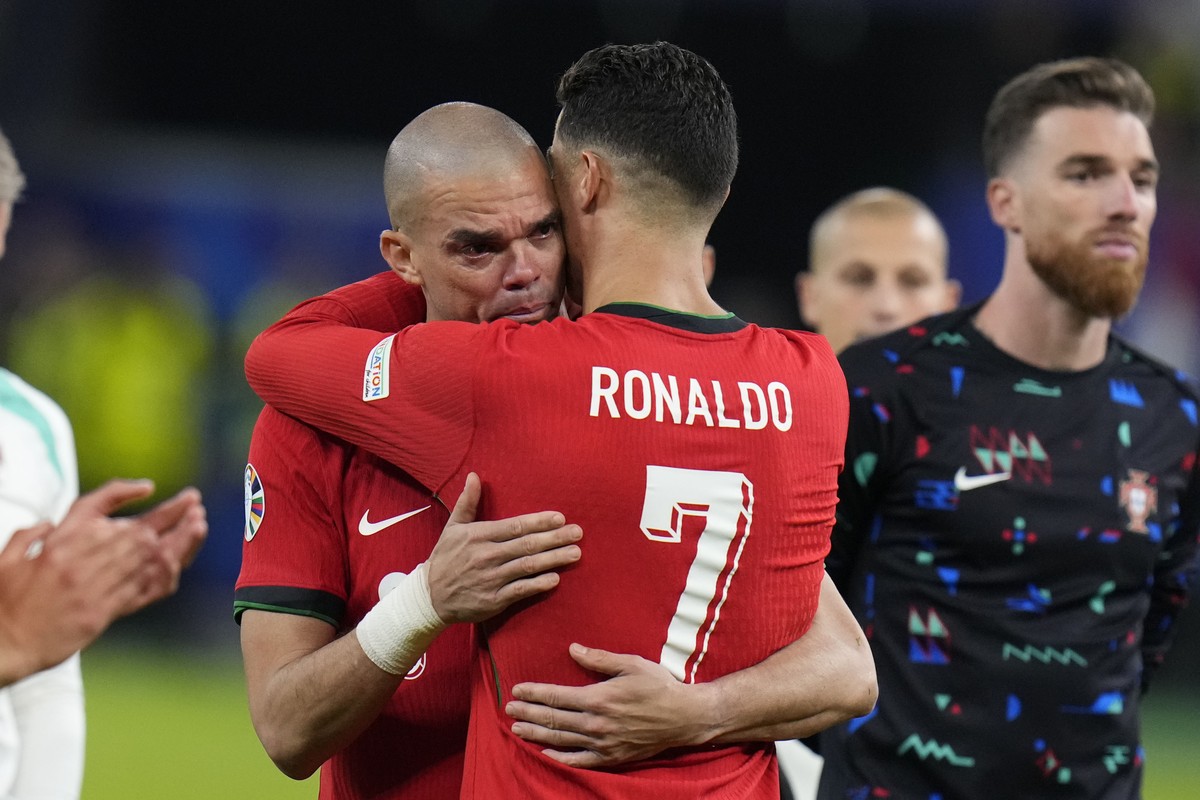 Portugal's Cristiano Ronaldo, right, embraces Pepe at the end of a quarter final match against France at the Euro 2024 soccer tournament in Hamburg, Germany, Friday, July 5, 2024. (AP Photo/Hassa ...