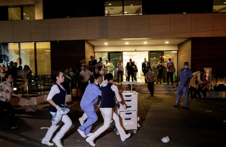 epa07838591 Staff move medical instruments from a hospital in Rio de Janeiro, Brazil, 12 September 2019. A fire broke out inside Badim Hospital and forced the evacuation of admitted patients. The fire ...