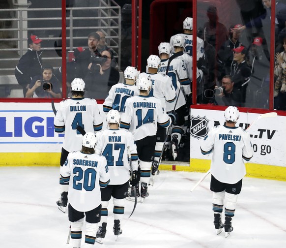 The San Jose Sharks skate off the ice after losing to the Carolina Hurricanes in a shootout in an NHL hockey game in Raleigh, N.C. Friday, Oct. 26, 2018. (AP Photo/Chris Seward)
