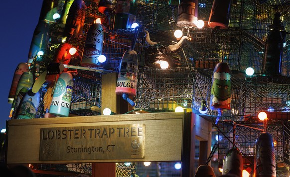 epa10331361 Painted buoys and lights adorn the Stonington Lobster Trap Tree at the town dock in Stonington, Connecticut, USA, 26 November 2022. This is the second year that the Ocean Community Chamber ...