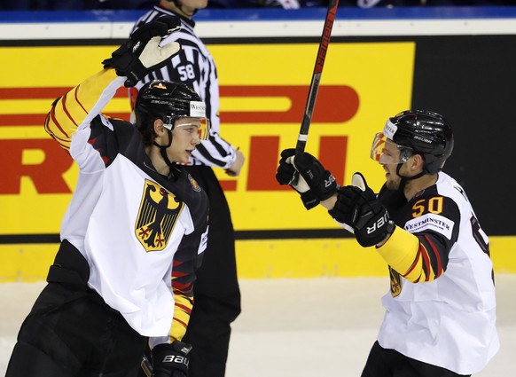 Germany's Moritz Seider, left, celebrates with Germany's Patrick Hager, right, after scoring his sides first goal during the Ice Hockey World Championships group A match between Germany and France at the Steel Arena in Kosice, Slovakia, Tuesday, May 14, 2019. (AP Photo/Petr David Josek)