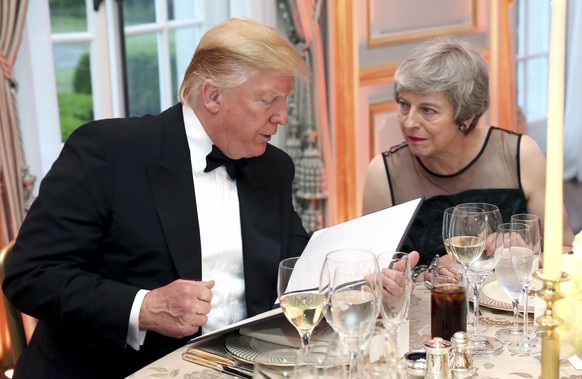 US President Donald Trump and Britain's Prime Minister Theresa May speak, during the Return Dinner in Winfield House, the residence of the Ambassador of the United States of America to the UK, in Rege ...