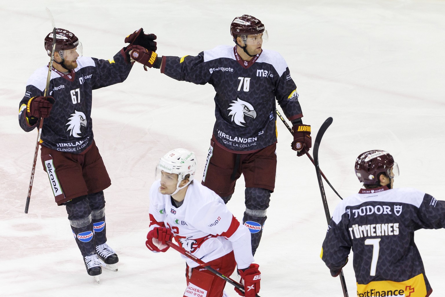 Geneve-Servette&#039;s forward Teemu Hartikainen #70 celebrates his goal with teammates Geneve-Servette&#039;s forward Linus Omark #67 and Geneve-Servette&#039;s defender Henrik Toemmernes, right, pas ...