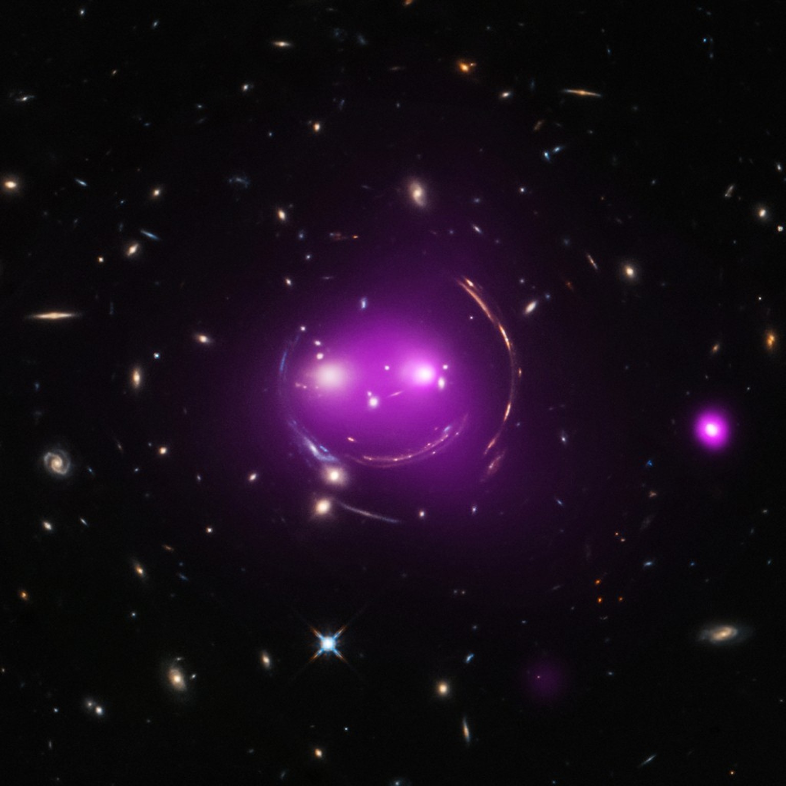 Gravity's Grin 
Albert Einstein's general theory of relativity, published over 100 years ago, predicted the phenomenon of gravitational lensing. And that's what gives these distant galaxies such a whi ...